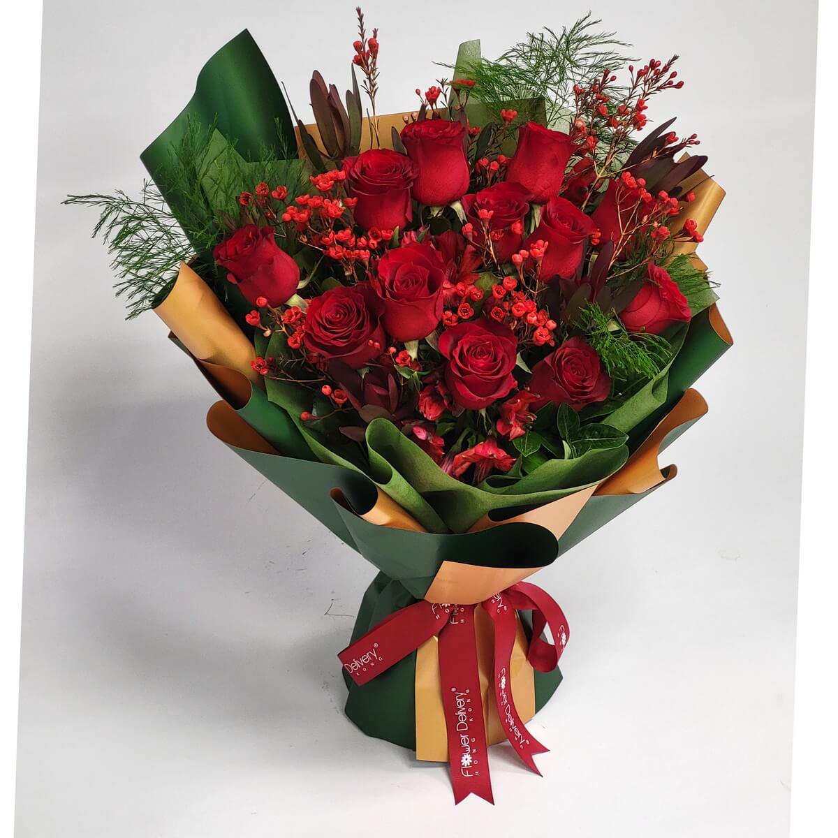 Full bouquet featuring red roses, red wax flowers, and alstroemeria with assorted foliage, wrapped in green and gold floral paper with ribbon - 紅玫瑰、紅色蠟花、百合花及多款綠葉花束,綠金花紙及絲帶包裝