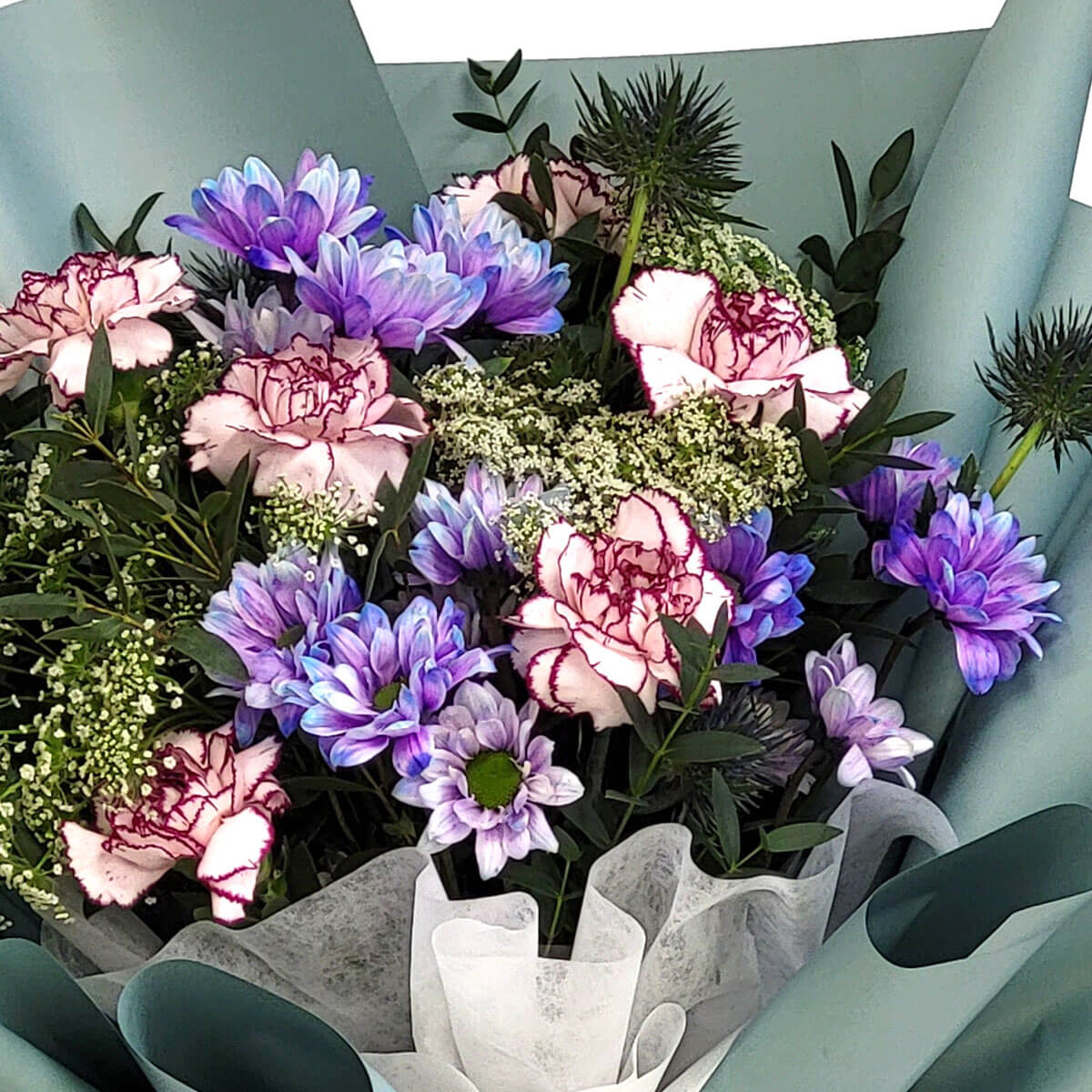 A soothing bouquet of lavender daisies, pink-rimmed carnations, and baby's breath evokes serenity and grace 紫色雛菊與粉邊康乃馨、滿天星相映成趣,展現恬靜優雅之美。