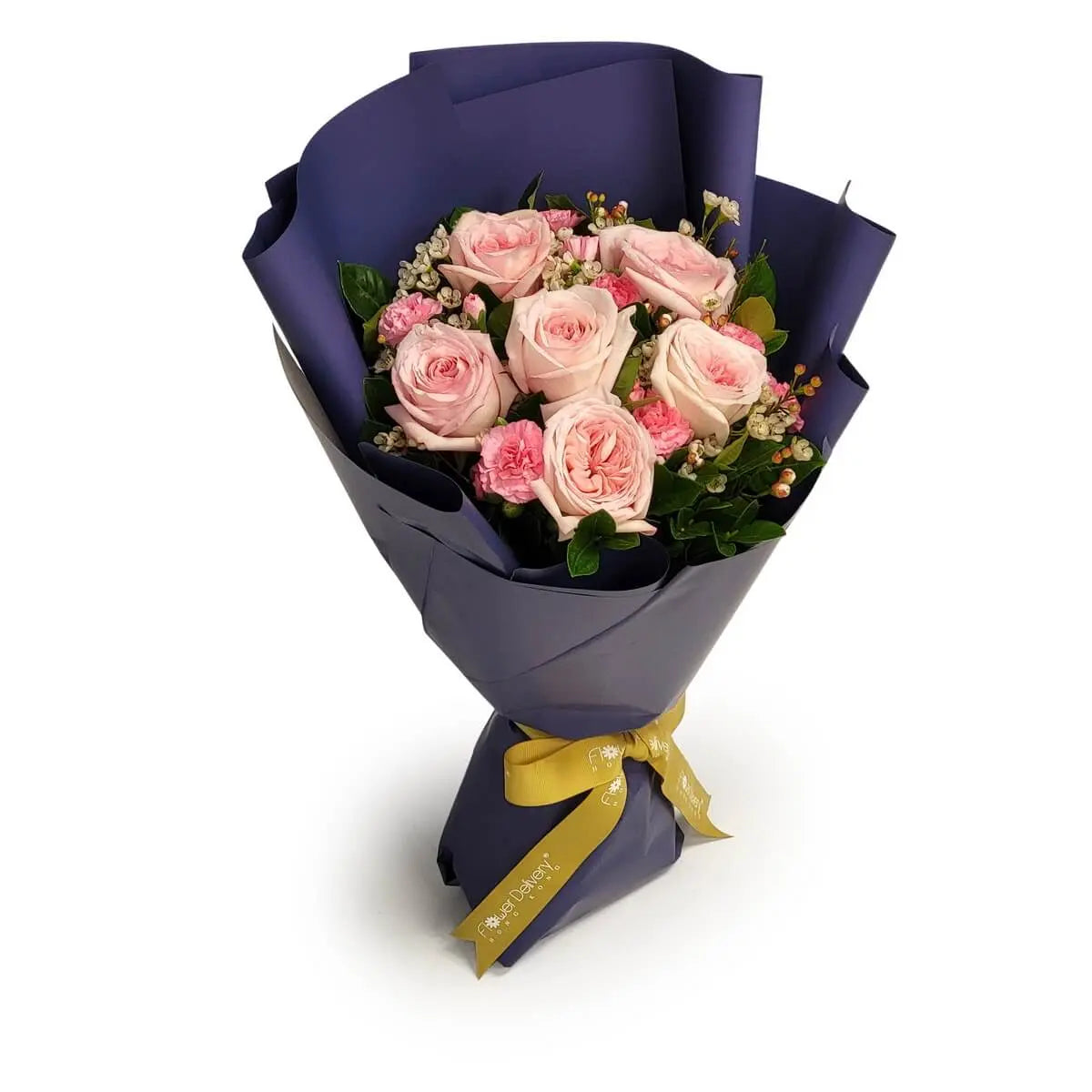 Elegant bouquet of pale pink roses, pink mini carnations, waxflowers, and foliage, wrapped in dark blue paper with gold ribbon | 淺粉玫瑰、小康乃馨、蠟花與綠葉,配深藍包裝及金色絲帶。