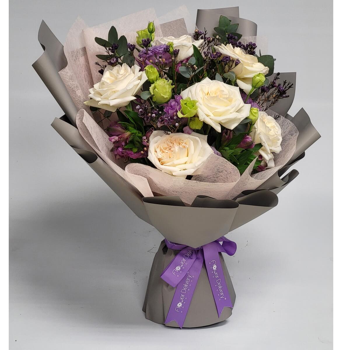 Elegant bouquet with creamy white roses, purple lisianthus, green rosebuds, dark wax flowers, and eucalyptus foliage, wrapped in grey paper with pink mesh and a purple ribbon - 奶白玫瑰配紫洋桔梗、綠玫瑰花苞、深色蠟花及尤加利葉,灰色花紙配粉紗及紫絲帶包裝