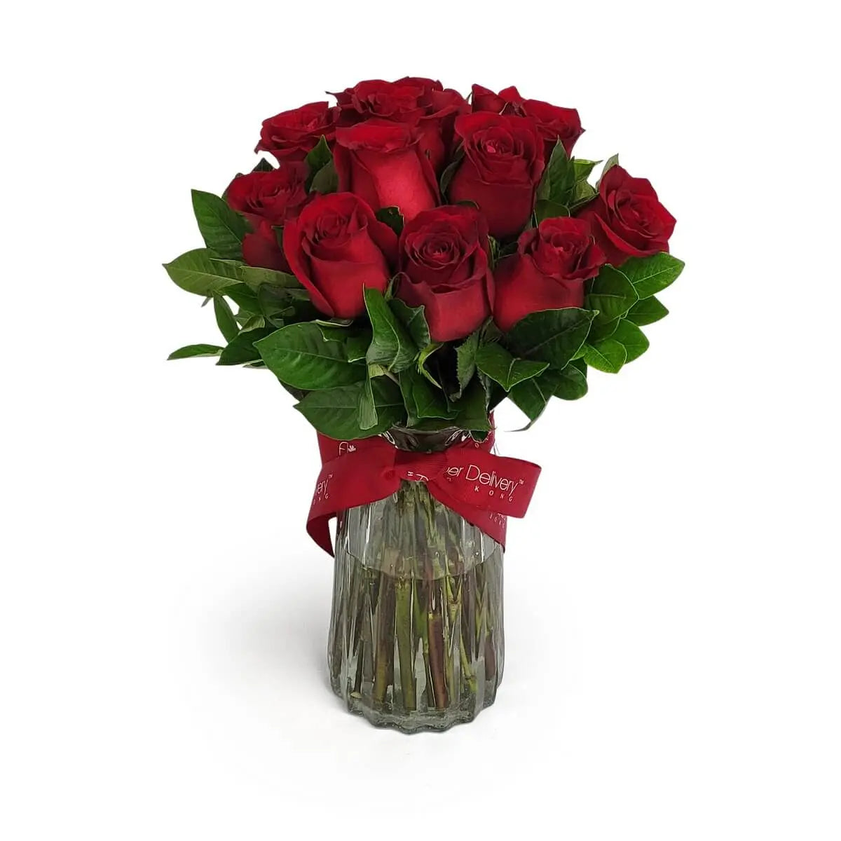 Elegant arrangement of red roses and green leaves in a fluted glass vase, finished with a red ribbon. | 紅玫瑰與綠葉插於條紋玻璃瓶中,綁以紅色絲帶,造型典雅。