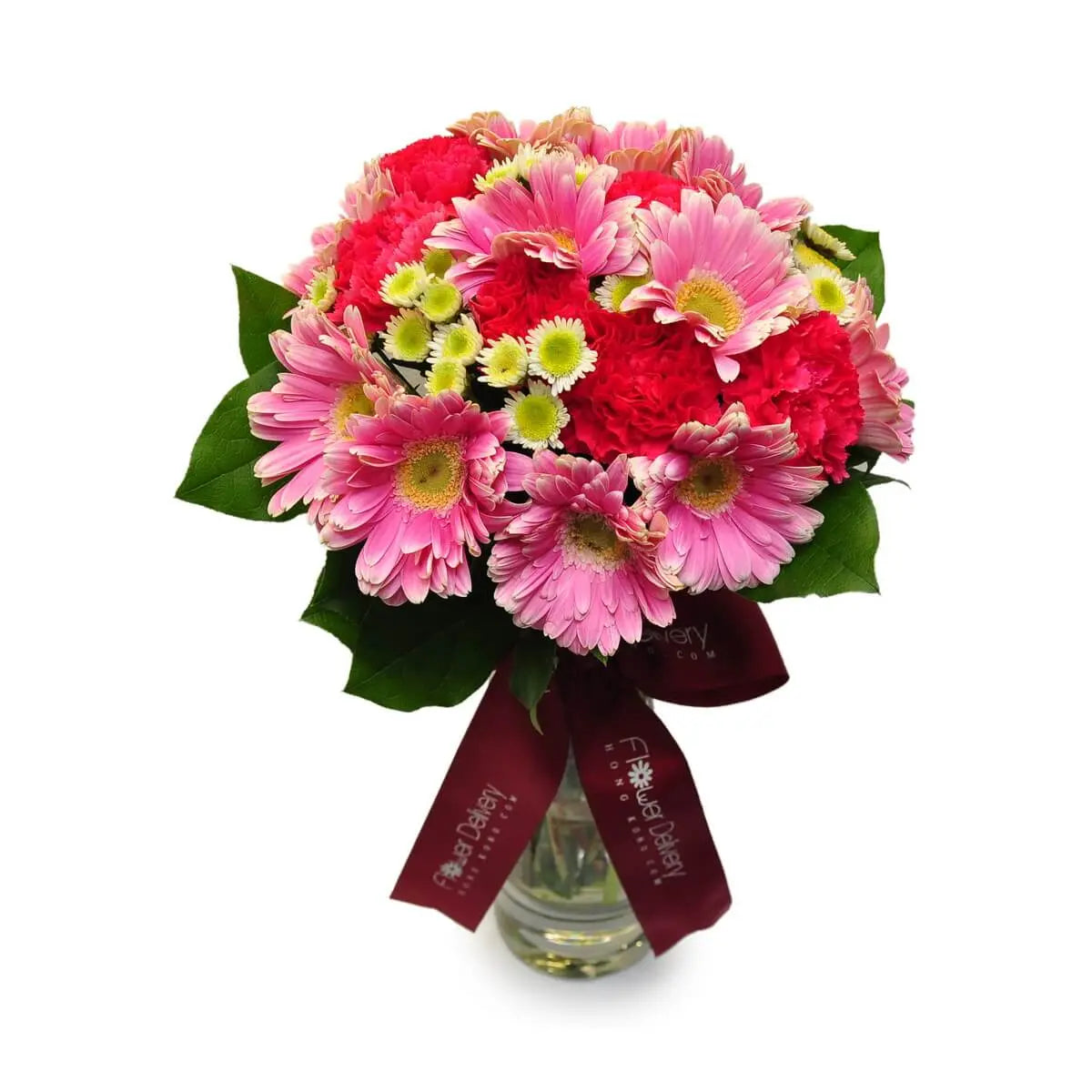 Glass vase filled with pink gerberas, red carnations, and yellow-white button chrysanthemums accented with green foliage | 粉紅非洲菊、紅康乃馨及黃白乒乓菊配上綠葉,設計於透明玻璃瓶中。