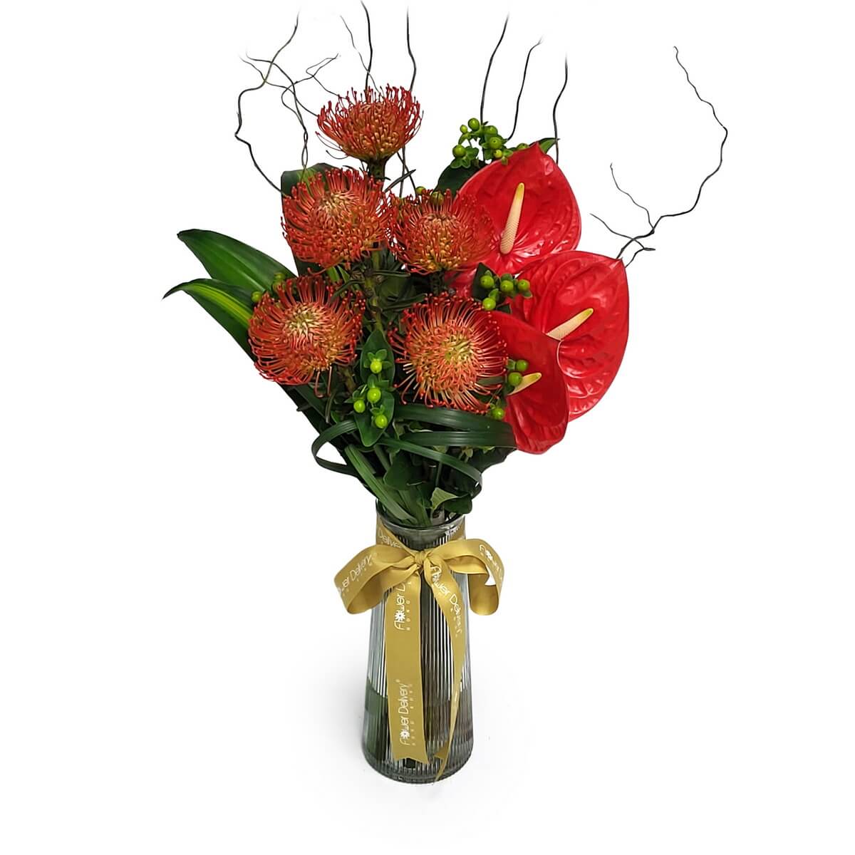 Elegant vase with red anthuriums, orange pincushion proteas, and lush greenery 金絲帶透明玻璃花瓶配紅火鶴橙紅針墊花及綠葉原相展示.