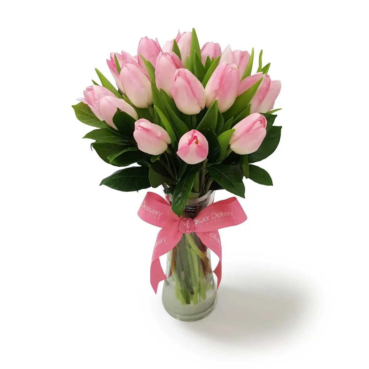 Elegant arrangement of pink tulips in a tall glass vase, accented with lush greenery and finished with a pink ribbon | 高身玻璃瓶插粉紅鬱金香及綠葉,瓶身綁有粉紅絲帶裝飾。