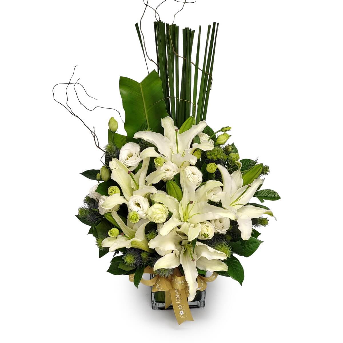 Full table arrangement of white lilies, ranunculus, blue thistles, greenery, tall leaves, and sculptural branches 白百合、洋牡丹、藍刺魟、綠葉及高枝條大型桌上花藝原圖