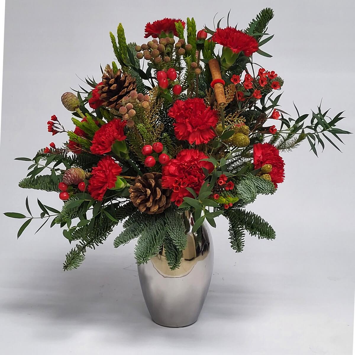 Original image of silver vase arrangement with red carnations, pinecones, cinnamon stick, red hypericum berries, waxflowers, fir and eucalyptus foliage - 銀色花瓶配紅康乃馨、松果、玉桂棒、紅繡球果、蠟花與松尤葉