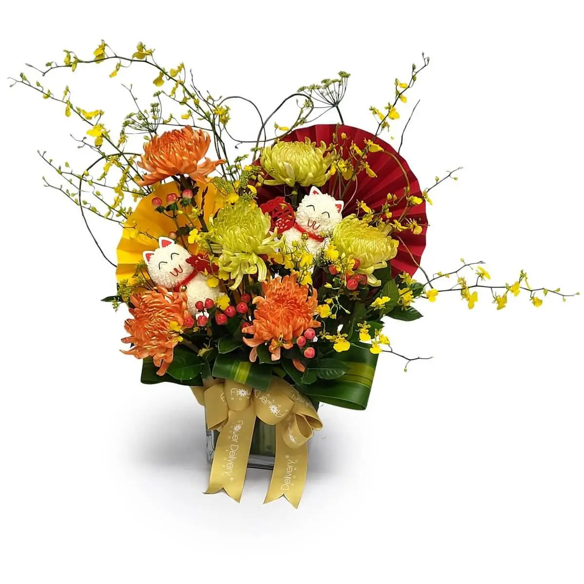 Arrangement of orange and green chrysanthemums, yellow dancing orchids, red berries, fan paper, and plush white cat figures in square glass vase | 橙綠菊花、黃舞春蘭、紅豆與公仔貓咪,配紅黃紙扇裝飾,插於方形玻璃瓶中,設計活潑搶眼