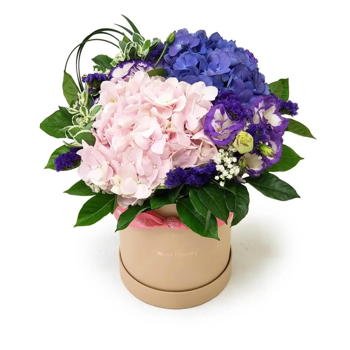 Floral hatbox with pink and blue hydrangeas, purple lisianthus, white statice, and mixed foliage in a beige round box | 粉藍繡球花、紫色桔梗、小白星花及綠葉組成花盒設計,盛放於米色圓形花盒中