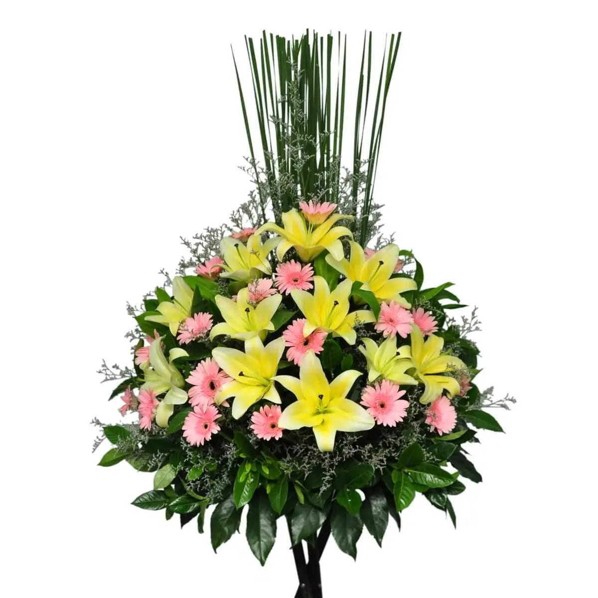 Standing floral arrangement featuring yellow lilies and light pink gerberas, accented with greenery and filler foliage | 站立式花牌由黃色百合與粉紅非洲菊構成,配以綠葉與襯葉點綴。