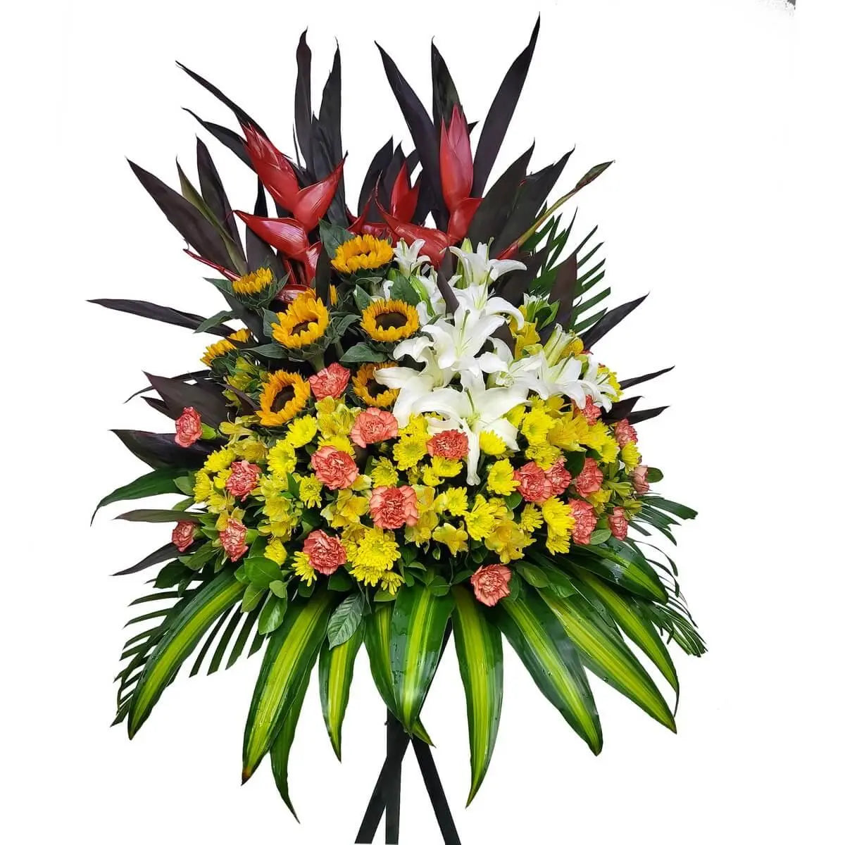 Standing arrangement with red heliconias, sunflowers, white lilies, yellow button chrysanthemums, coral carnations, and lush greens - 企身花牌設計,紅天堂鳥、向日葵、白百合、黃乒乓菊及橙康乃馨搭配熱帶綠葉,色彩鮮明。