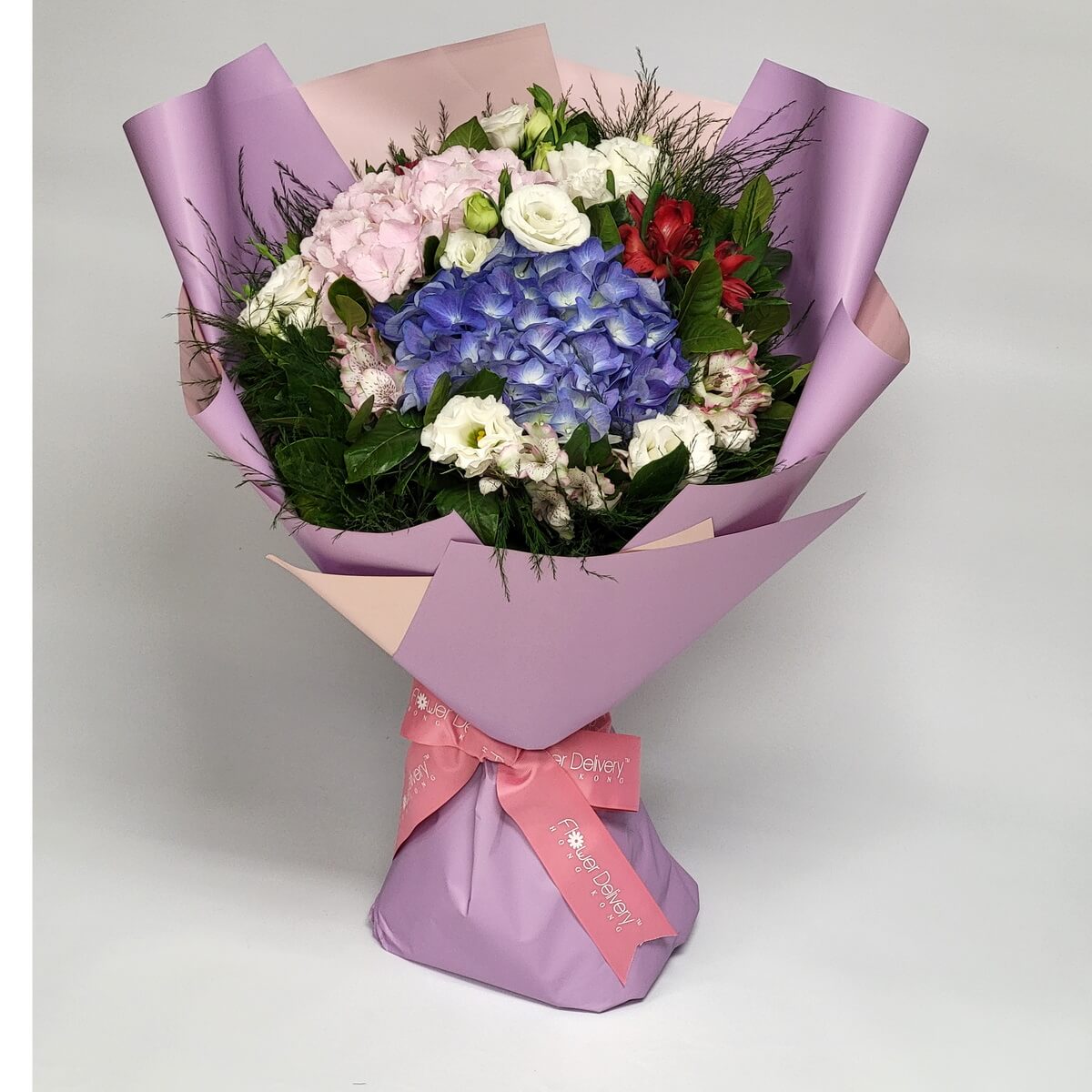 Original image of mauve-wrapped bouquet featuring purple and pink hydrangeas, white lisianthus, red alstroemeria, and lush greenery - 紫粉繡球花、白洋桔梗、紅六出花及翠綠襯葉配紫粉包裝的花束