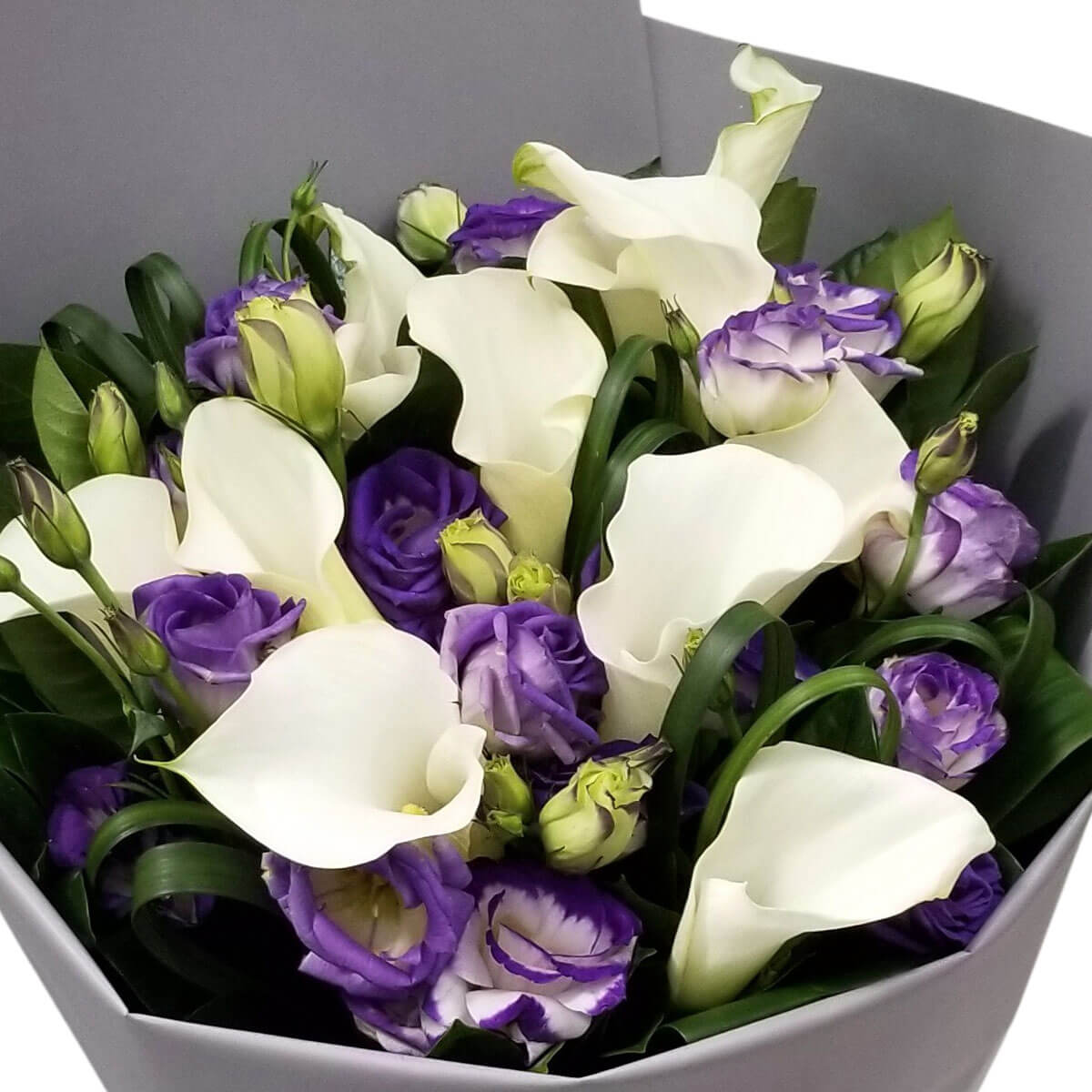 Modern bouquet with pure white calla lilies and violet-edged eustomas, exuding timeless charm 馬蹄蓮搭配紫邊桔梗，花藝設計俐落大方，盡展典雅品味。