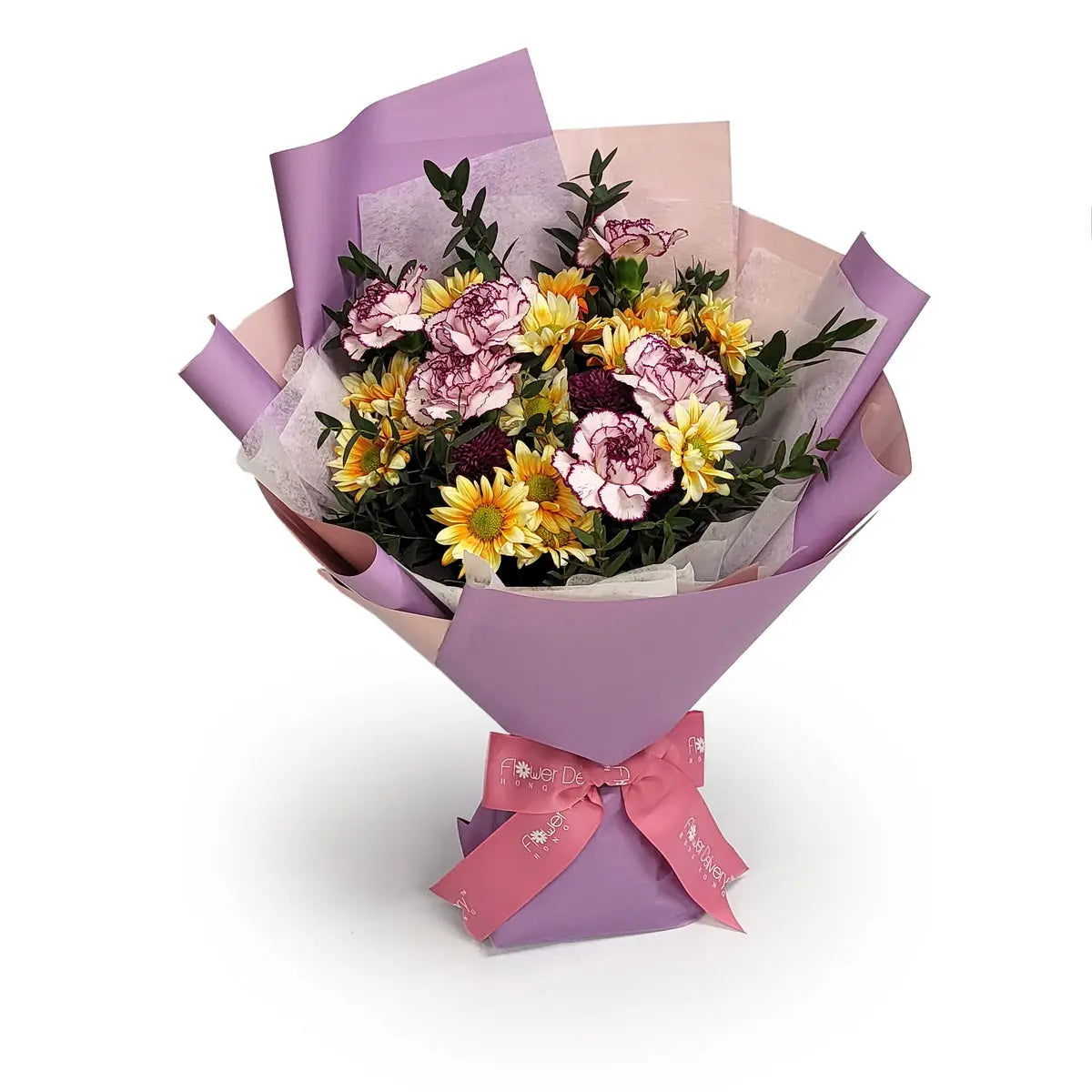 Bouquet of yellow chrysanthemums, pink carnations with purple edges, and foliage, wrapped in lavender and soft pink paper with a pink ribbon. 黃菊花與紫邊粉紅康乃馨花束，配綠葉與粉紫色包裝及粉絲帶。