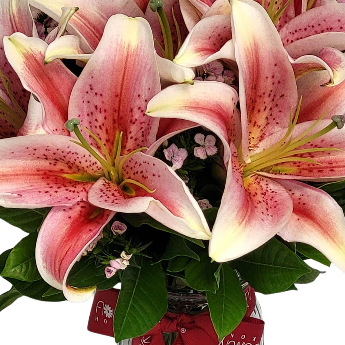 Bouquet of stargazer lilies with vibrant pink petals and speckles, paired with soft greenery and accent flowers 粉紅斑點百合與綠葉及小花相襯，營造典雅浪漫的花束。