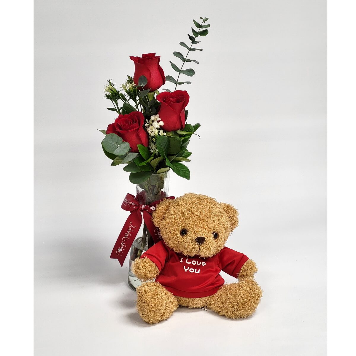 Original photo of glass vase with red roses, filler flowers, eucalyptus, and a plush teddy bear in red shirt - 紅玫瑰、配花及尤加利葉玻璃瓶插花配紅衣毛公仔