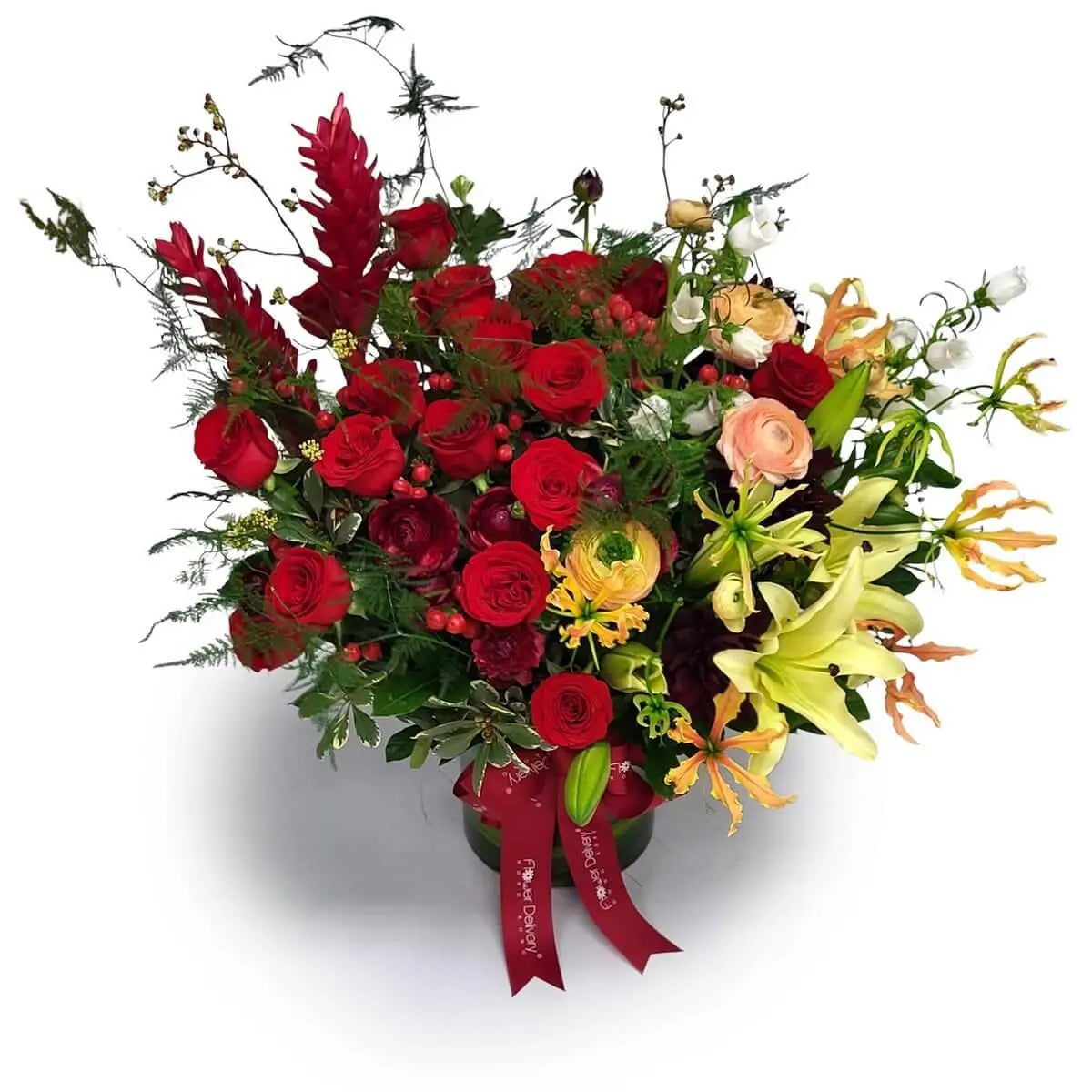 Vibrant arrangement featuring red roses, yellow lilies, gloriosa, ranunculus, ginger flowers, and spray roses with lush greens | 鮮豔花藝包含紅玫瑰、黃百合、嘉蘭花、洋牡丹、薑花與迷你玫瑰，配以濃密綠葉設計。 