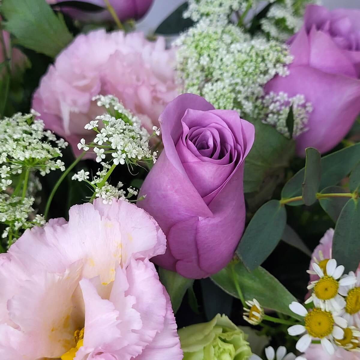 Detailed view of lavender roses with pink lisianthus, white Queen Anne’s lace, chamomile, and eucalyptus leaves | 薰衣草玫瑰、粉紅桔梗、白色蛇目菊與洋甘菊花細節特寫。