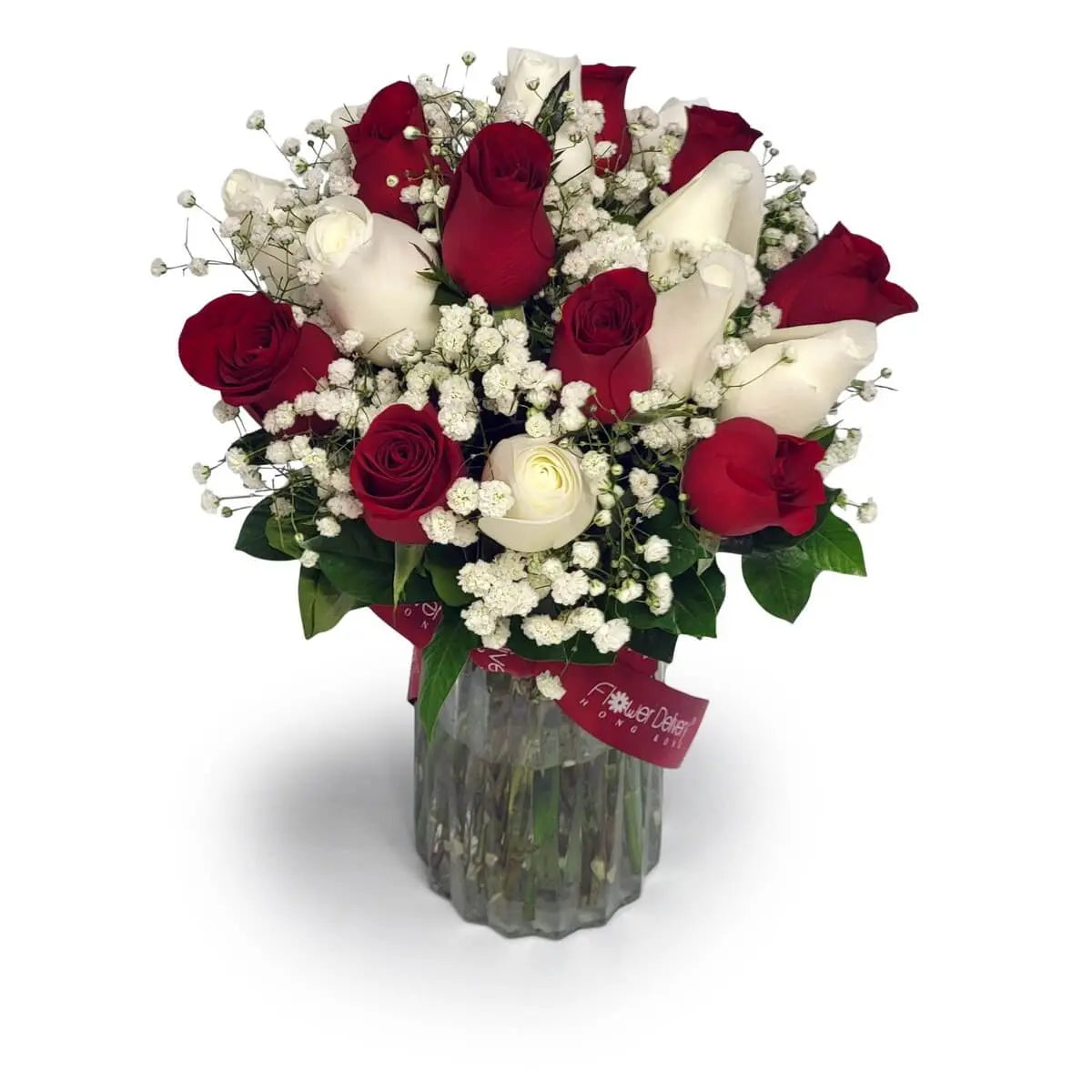 Floral arrangement of red and white roses with baby's breath and green foliage, placed in a clear ribbed glass vase tied with a red ribbon. 紅白玫瑰、滿天星與綠葉插於透明玻璃花瓶，綁以紅色絲帶。