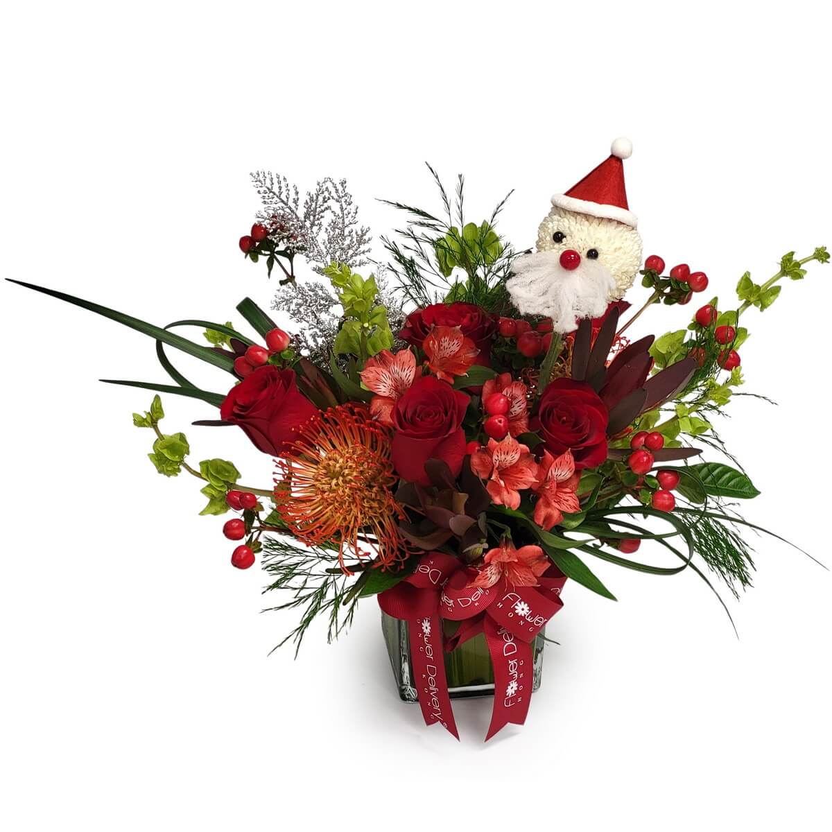 Seasonal floral arrangement showing red roses, pincushion protea, alstroemeria, red berries and greenery arranged in a modern glass vase. 聖誕玫瑰花藝配針墊花及漿果