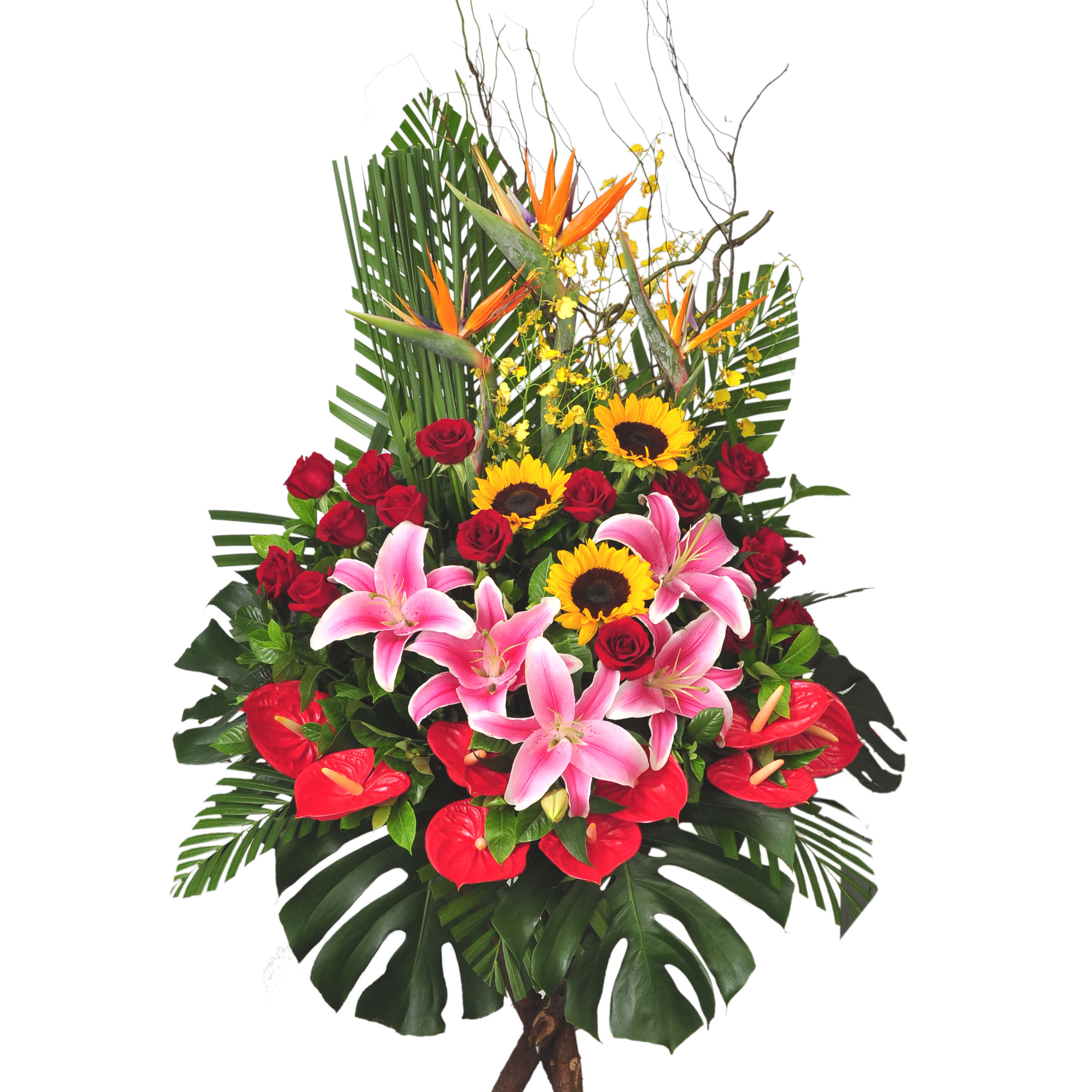 A bold arrangement with pink lilies, red roses, sunflowers, anthuriums, and birds of paradise framed by lush tropical greens – 粉百合、紅玫瑰、向日葵與火鶴花點綴天堂鳥，搭配熱帶綠葉，展現奔放風格