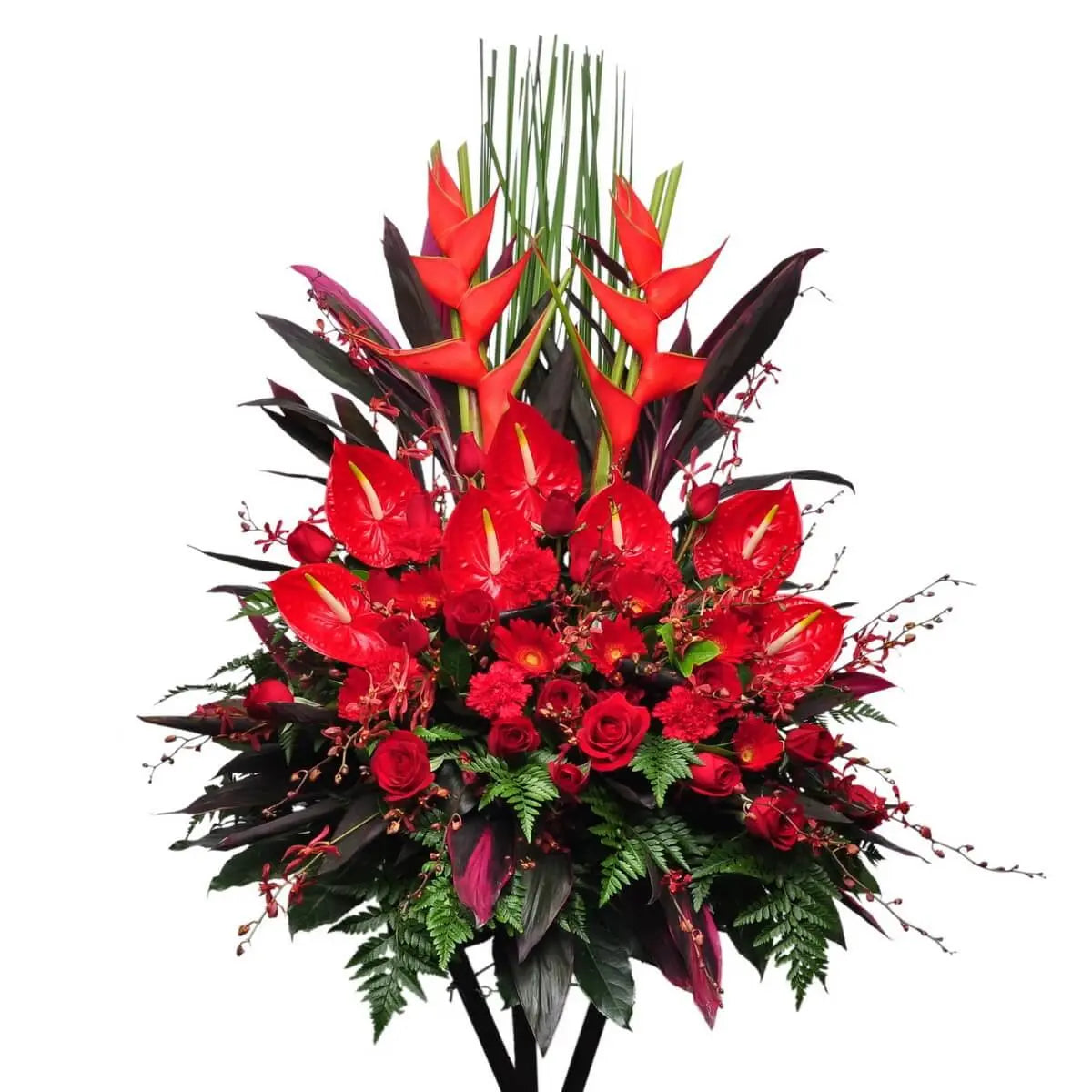 Standing arrangement featuring red heliconias, anthuriums, roses, carnations, gerberas, orchids, and layered tropical greens - 企身花牌設計含紅色天堂鳥、火鶴、玫瑰、康乃馨、非洲菊與紅蘭花，襯以層次感熱帶葉材。