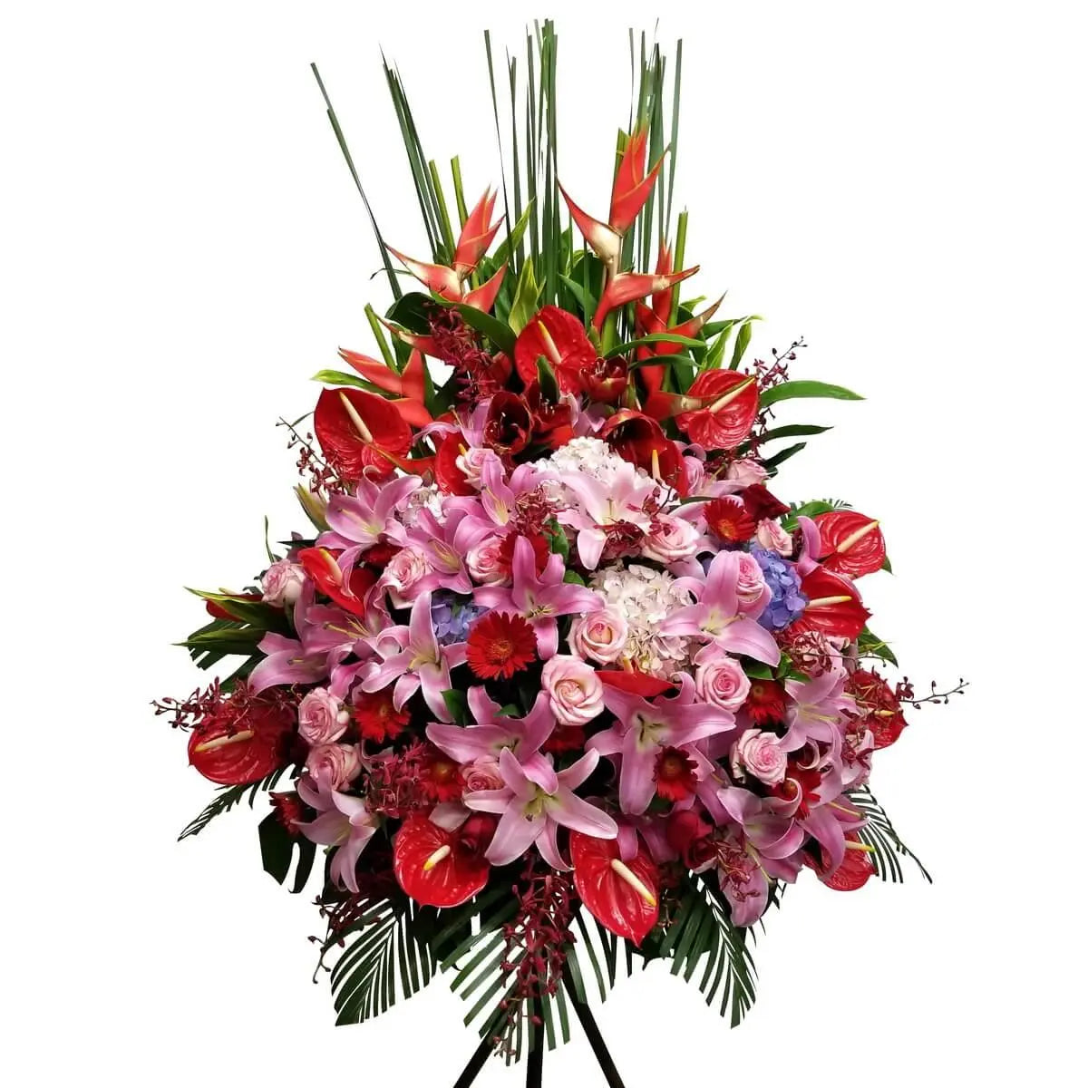 Standing floral display featuring pink lilies, roses, red anthuriums, heliconias, orchids, hydrangeas, and tropical foliage. 大型企牌花籃以粉百合、粉玫瑰、紅掌、天堂鳥、蘭花、繡球花及熱帶葉材組合而成。