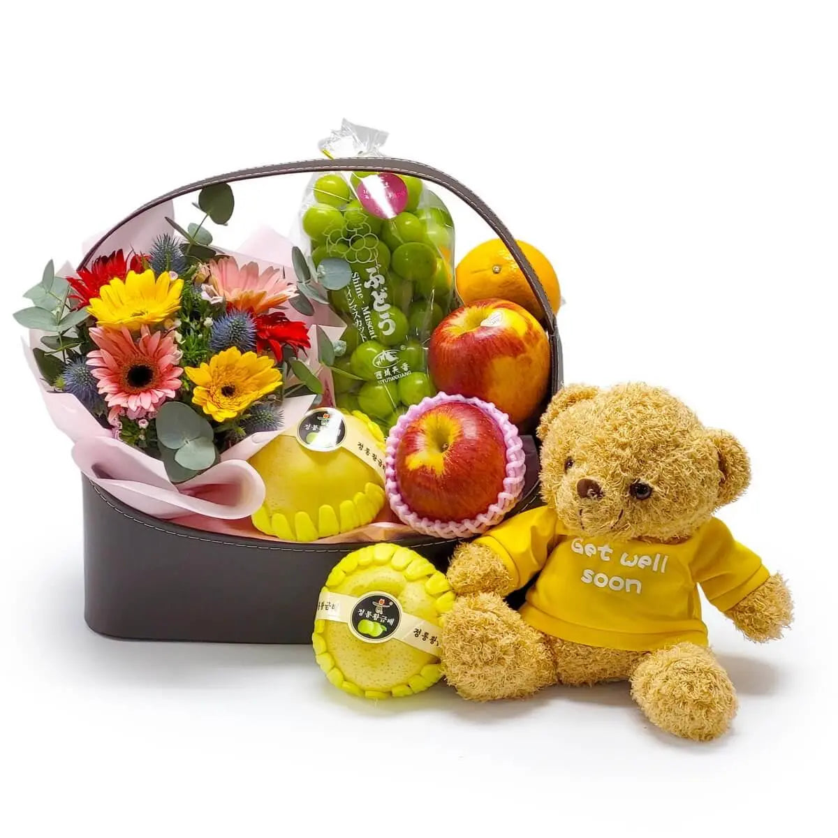 Hamper featuring gerbera bouquet, apples, Korean pears, grapes, citrus fruits, and a plush bear in a yellow “Get well soon” shirt | 太陽花花束配蘋果、韓國香梨、青提子及柑橘水果，附穿上黃色「早日康復」字樣衣服的毛公仔，傳遞祝福心意。