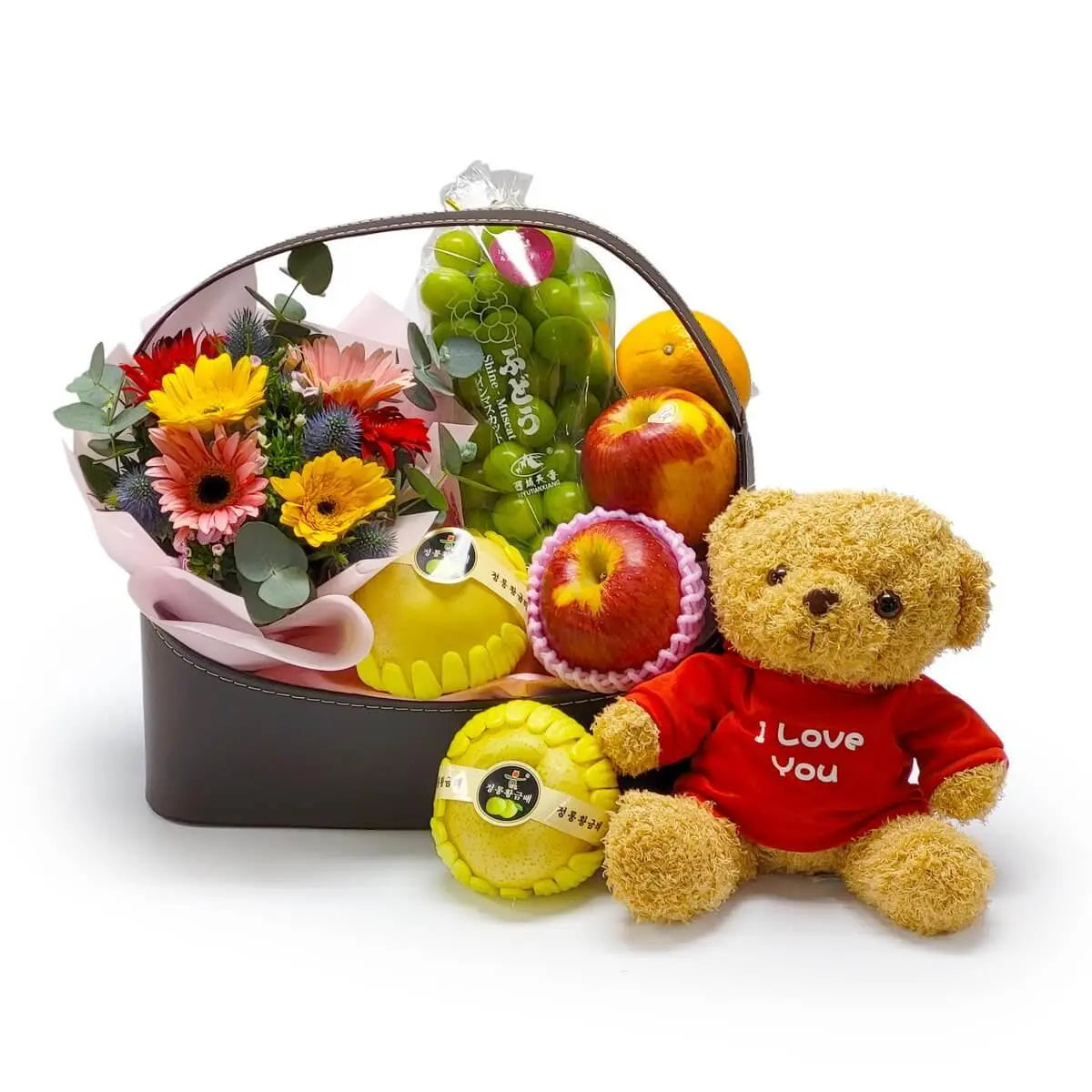 Hamper with gerbera bouquet, apples, Korean pears, grapes, citrus fruits, and a plush bear in red “I Love You” shirt | 太陽花花束配蘋果、韓國香梨、青提子及柑橘水果，搭配紅衣毛公仔的禮籃設計，溫馨可愛。