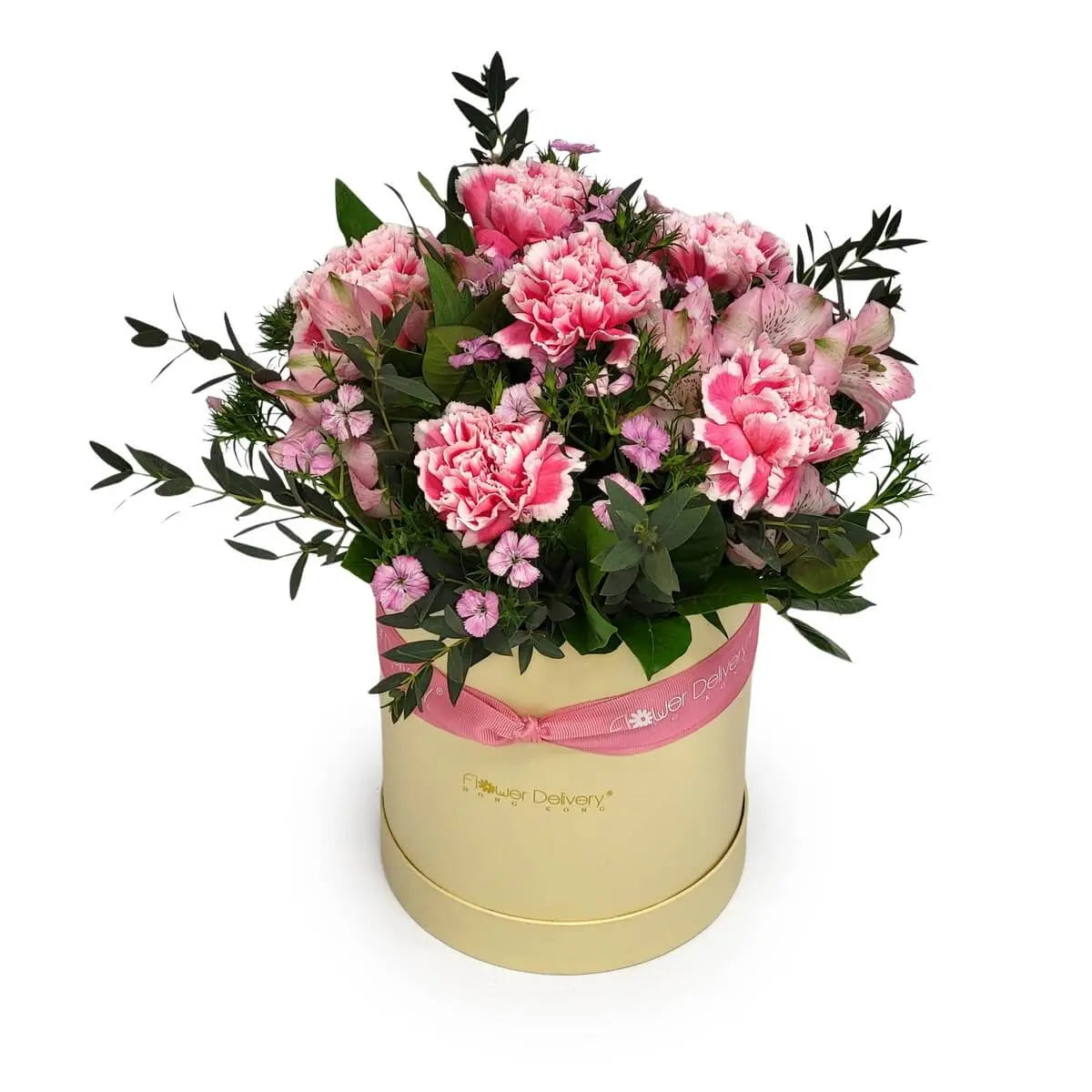 Floral box featuring pink carnations, violet lisianthus, white blossoms, and greenery in a beige round box with a pink ribbon | 圓形米色花盒內有粉紅康乃馨、紫桔梗、白色小花與綠葉，配粉紅絲帶裝飾