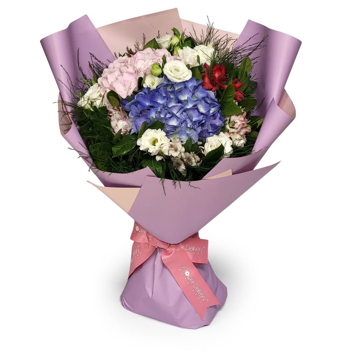 Full hand-tied bouquet featuring purple hydrangea, light pink hydrangea, white lisianthus and red and pink alstroemeria with layered greenery, wrapped in lavender paper.